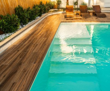 Modern villada temiz mavi suyla yüzme havuzu girişi. Havuza girmek için uygun bir yer. Merdivenli özel yüzme havuzu