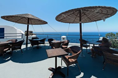 Terrace with caldera view and umbrellas in Oia, Santorini, Greece