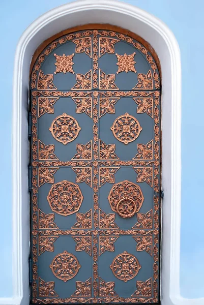 Ornate bras patterned door of St. Michael's Golden-Domed Monastery in Kyiv Ukraine