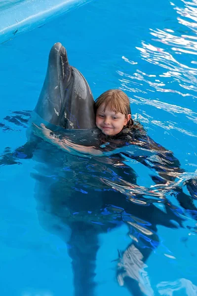 Μικρό Κορίτσι Αγκαλιάζει Ένα Δελφίνι Στη Συνεδρία Θεραπεία Δελφινιών — Φωτογραφία Αρχείου