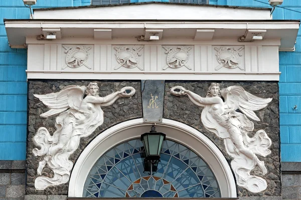 Bas relief with two angels on facade of old building in Kyiv, Ukraine