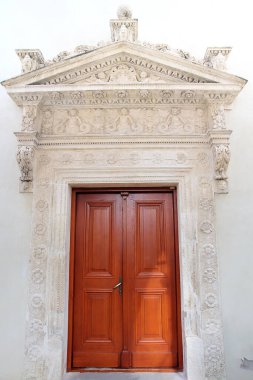 Polonya 'daki Krasiczyn şatosunun dekoratif alçılı turuncu ahşap kapısı.