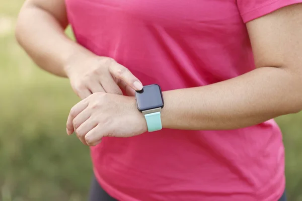Woman hands setting smart watch. Technology and people concept
