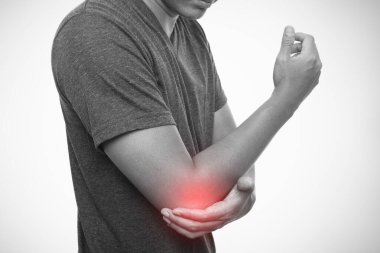 Man pain in the elbow isolated on gray background clipart