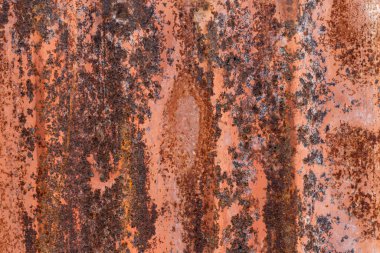 Paslanmış yüzeyi ve yıpranmış endüstriyel detayları olan turuncu paslı metal doku.