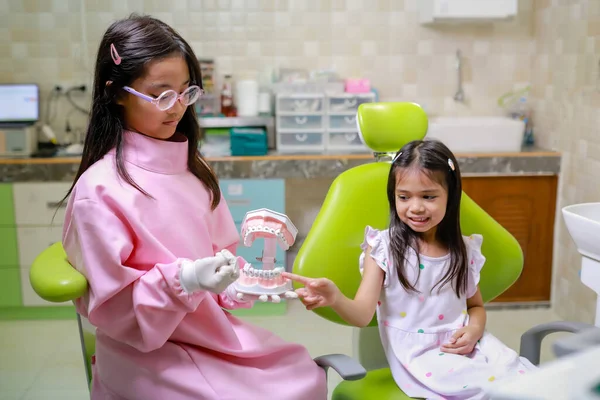 stock image This cute girl is getting ready for her regular dental appointment at the dentist's office checkup.pediatric medical care concept.