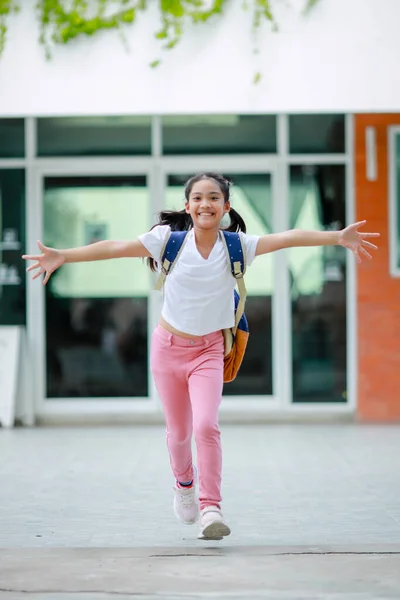 stock image Little kid girl asian with a backpack going to school with fun. which increases the development and enhances the learning skills. Concept Back to school.