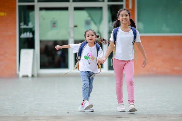 stock image Little kid girl asian with a backpack going to school with fun. which increases the development and enhances the learning skills. Concept Back to school.