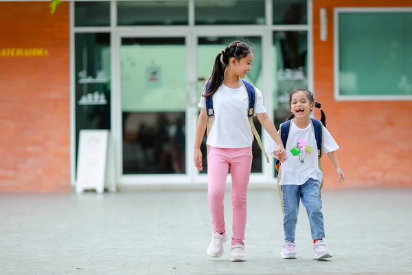 stock image Little kid girl asian with a backpack going to school with fun. which increases the development and enhances the learning skills. Concept Back to school.