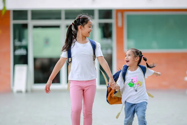 stock image Little kid girl asian with a backpack going to school with fun. which increases the development and enhances the learning skills. Concept Back to school.