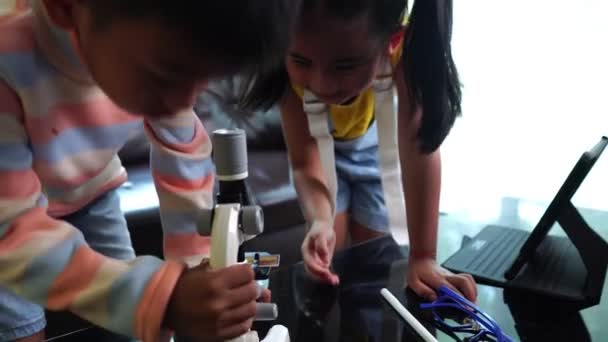 Niños Asiáticos Que Asisten Clases Línea Desde Casa Usando Microscopio — Vídeo de stock