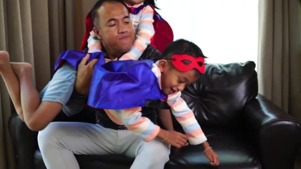 Asiatisk Far Leger Med Sine Små Børn Iført Superhelte Kostumer – Stock-video