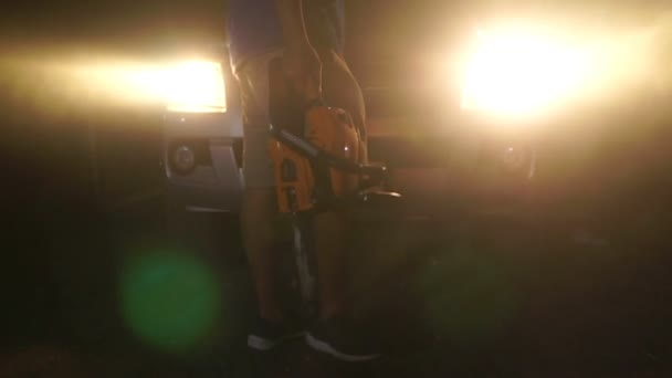 Male Murderer Walking Night Holding Chainsaw — Video Stock