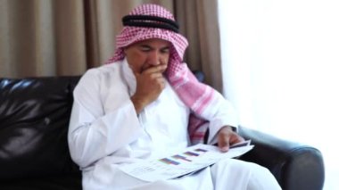 Happy middle eastern businessman working from home