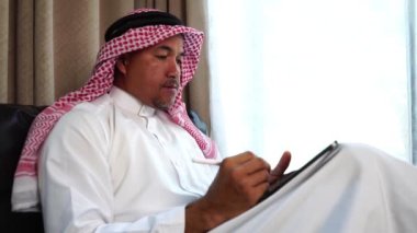 Happy middle eastern businessman working from home