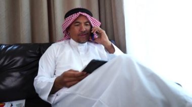 Happy middle eastern businessman working from home