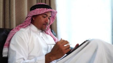 Happy middle eastern businessman working from home