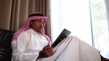 Happy middle eastern businessman working from home