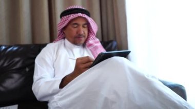 Happy middle eastern businessman working from home