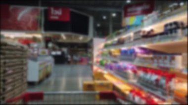 Shoppers point of view moving through supermarket aisle