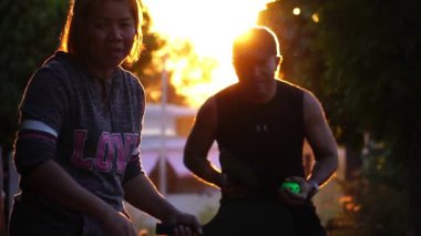 people having fun playing pickleball at sunset