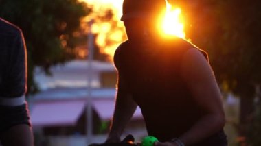 people having fun playing pickleball at sunset