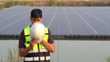 Middle Eastern engineer inspecting solar farm