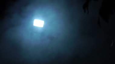 White light with blue smoke on dark background 