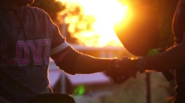 Couple having fun and playing pickleball at sunset