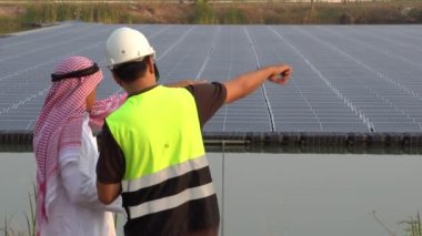 Footage 4K: Middle Eastern Arab inspecting solar farm with engineer