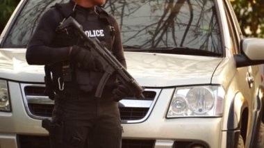 close-up footage of police officer in uniform near vehicle