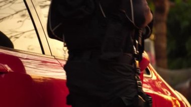 close-up footage of police officer in uniform near vehicle