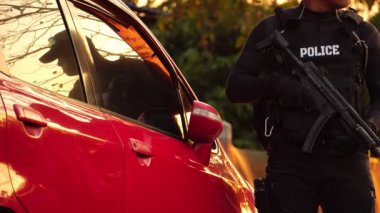 close-up footage of police officer in uniform near vehicle