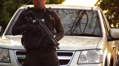 close-up footage of police officer in uniform near vehicle