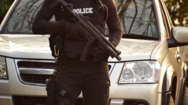 close-up footage of police officer in uniform near vehicle