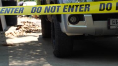 close-up footage of do not enter ribbon at place of crime
