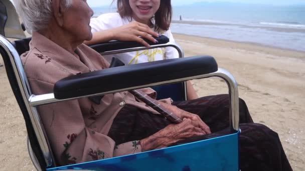 Πλάνα Αργή Κίνηση Ηλικιωμένη Γυναίκα Κάθεται Αναπηρική Καρέκλα Στην Παραλία — Αρχείο Βίντεο