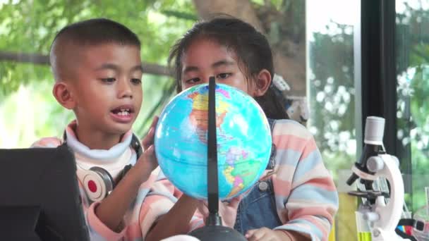 Asian Children Inspecting Globe — Stock Video