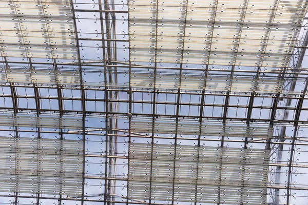 stock image Iron construction with glass seen from below. Glass roof of a modern building