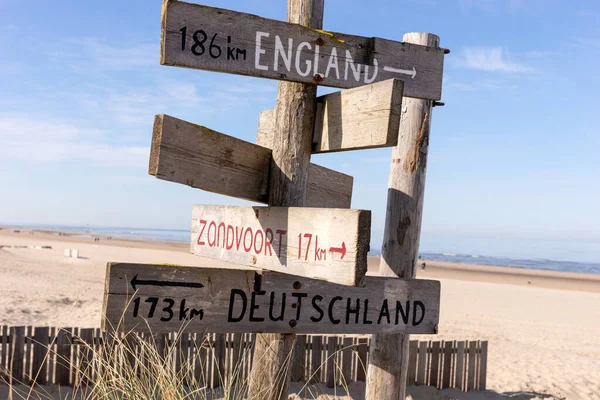 stock image Wooden information board with distance to England, Germany and Zandvoort. On the North Sea beach in Noordwijk. Netherlands