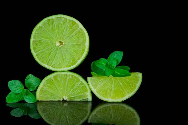 stock image Still life, lemon and lime on black background