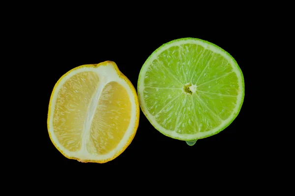 stock image Still life, lemon and lime on black background