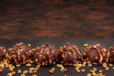 Cosmetics on a red background. There are lipstick, eyeshadow, powder, blush, eyeliner,