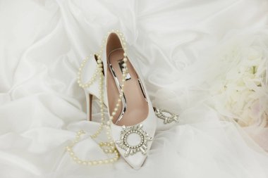 high heel shoes  on a whiite silk background