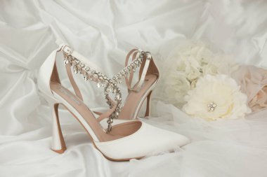 high heel shoes  on a whiite silk background