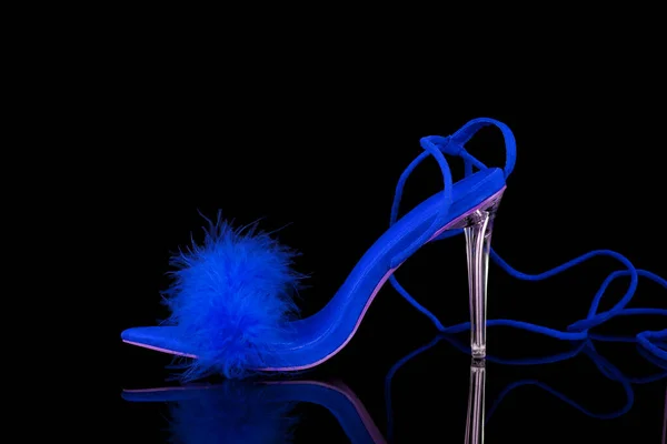 stock image sexy, blue strappy high heel shoes  on a black background