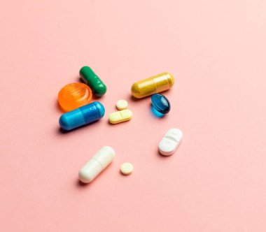 Different types of pills and capsules on a solid background, medicine to improve life, pain relief, health
