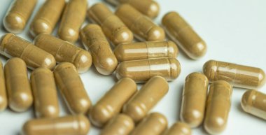 Ashwagandha capsules on a white background, tablets supporting immunity, supplementation of the body with essential ingredients