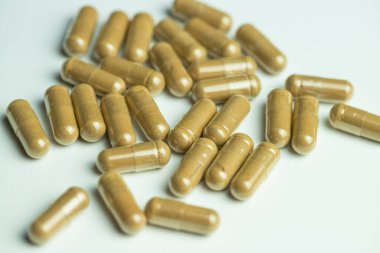 Ashwagandha capsules on a white background, tablets supporting immunity, supplementation of the body with essential ingredients
