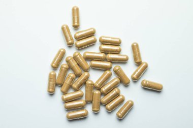 Ashwagandha capsules on a white background, tablets supporting immunity, supplementation of the body with essential ingredients